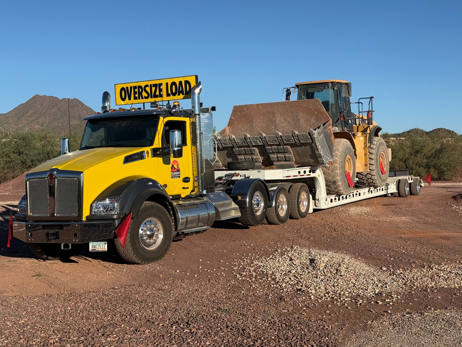 Sunny Heavy Hauling truck transporting heavy equipment